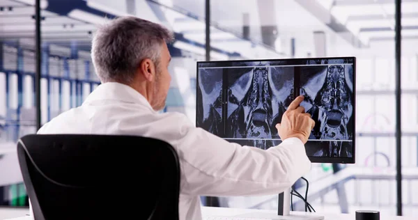 Doctor Screening Spine Bones X Ray On Computer