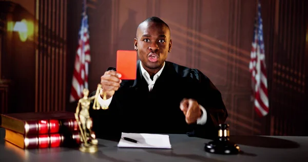 Judge In Courtroom Showing Red Card. Trial Rules And Law