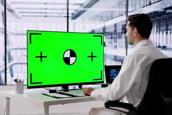 Doctor Using Desktop Computer With Green Screen