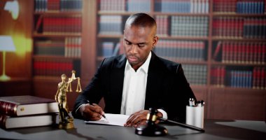 Masasında hukuk belgesi olan bir avukat. Adalet Divanı