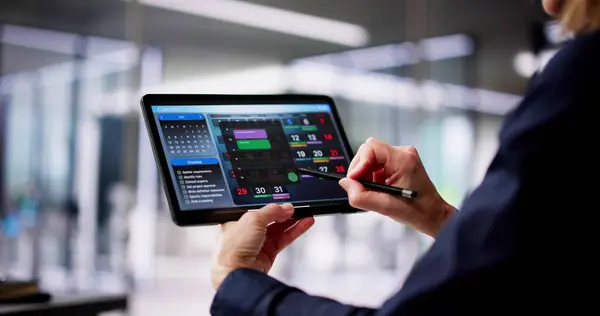 Executive Using Digital Calendar Agenda On Tablet