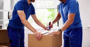 Group of Movers Pack Boxes for Delivery to Residential House, Organizing Furniture with Driver in Up-and-Coming Business. clipart