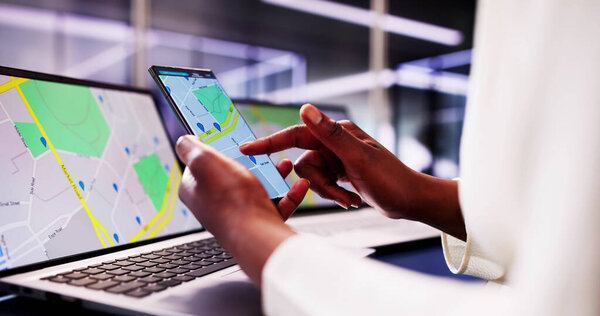 African woman using smartphone to search for property listings with GPS navigation map. Court navigator locating bank office online.