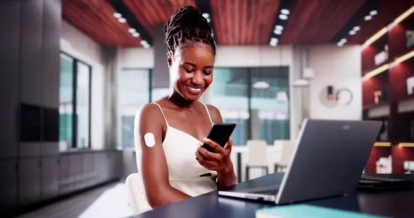 stock image Woman Testing Glucose Level With Continuous Glucose Monitor On Mobile Phone