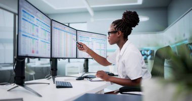 Hospital Doctor Using Spreadsheet For Billing Codes On Desktop