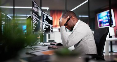 Unhappy Sad Developer Programmer Man In Stress Coding Software On Computer
