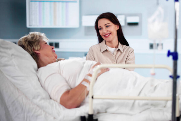 Patient In Hospital Visit By Family. Daughter Visiting Older Mother