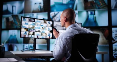 Güvenlik Sistemi CCTV İzleme Odası. Telsiz kullanan adam