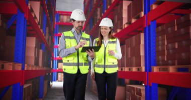 Yeni depo çalışanı tablet kullanarak deneyimli yöneticilerden eğitim alıyor.