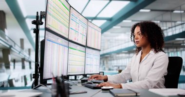 Hospital Doctor Using Spreadsheet For Billing Codes On Desktop