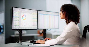 Hospital Doctor Using Spreadsheet For Billing Codes On Desktop