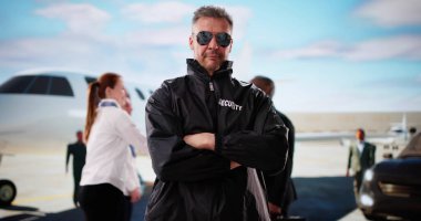 Güvenlik görevlisi havaalanındaki özel jeti telsizle izliyor..