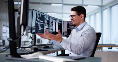 Unhappy Sad Developer Programmer Man In Stress Coding Software On Computer