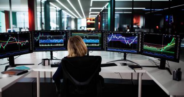 Başarılı Borsacı Çoklu Bilgisayar Ekranlarındaki Piyasa Eğilimlerini Analiz Ediyor.