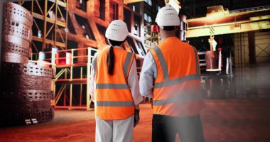 Çelik Fabrikası Mühendisleri Üretim Tesisindeki Kadın İronisini Tartışıyor. Muhtemel Meslekler: Mühendis, Kaynakçı