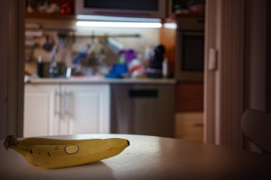 Masada iki muz var, mutfak arka planda bulanık görünüyor..