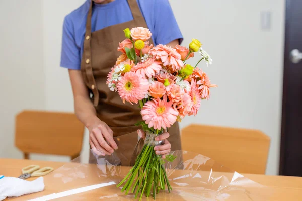Female florist make a bouquet