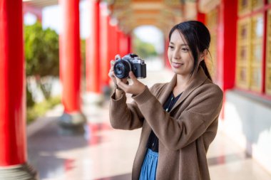 Travel woman use digital camera to take photo in Chinese temple