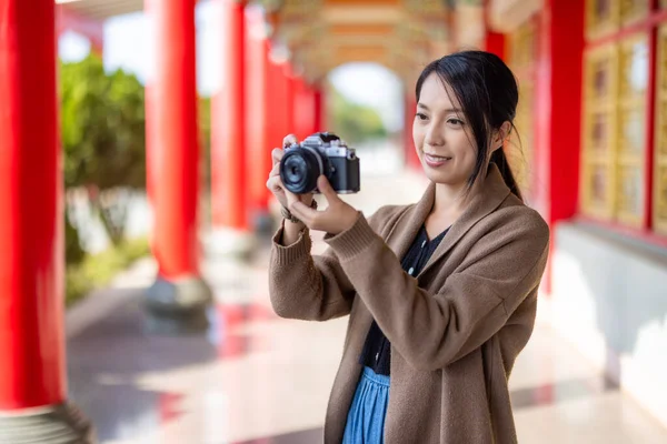 旅行の女性は中国の寺院で写真を撮るためにデジタルカメラを使用します — ストック写真