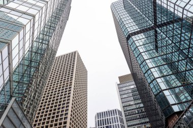 Looking up at towering skyscrapers clipart