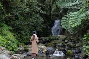 Tourist woman go hiking view the Wufengqi waterfall in Yilan of Taiwan