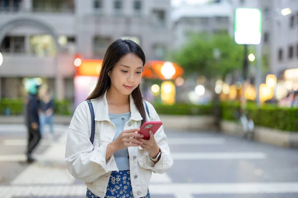 stock image Woman use mobile phone in city at night