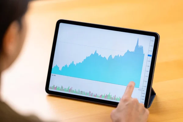 stock image Woman look at the digital tablet with stock market data