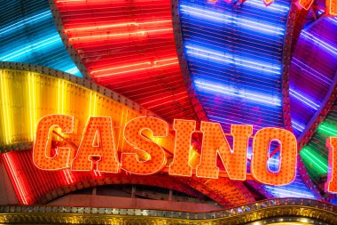 Neon casino sign lit up over the building at night