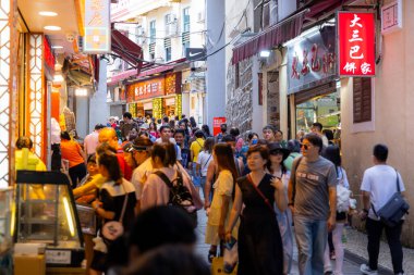Macau - 03 July 2023: Crowded of people walk in the tourist landmark 
