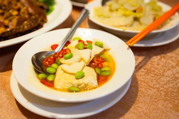 Chinese style stinky tofu with lots of others dishes in restaurant
