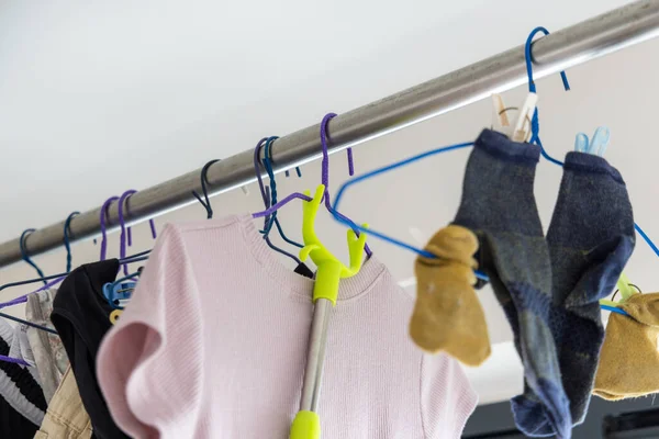 Dry laundry clothes and hanging up in indoor