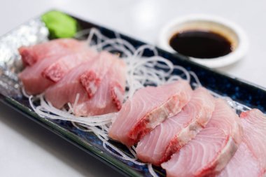 Slice of fish sashimi on plate