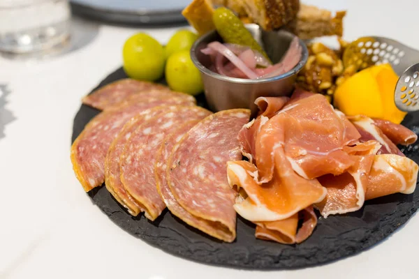 Appetizers cold cuts board with slice of ham and toast
