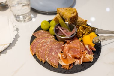 Aperatifler bir dilim jambon ve tostla servis ediliyor.