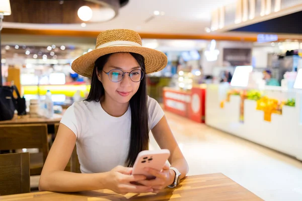 Woman use of mobile phone in restaurant
