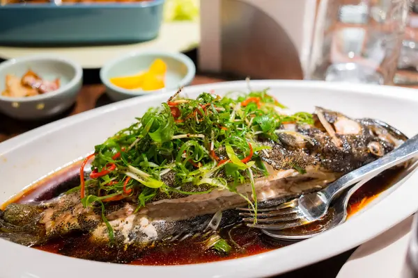 Steamed fish with soy sauce and green onion