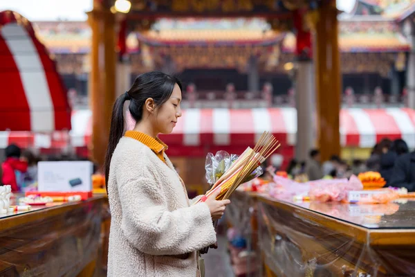 Asian woman pray in Chinese temple