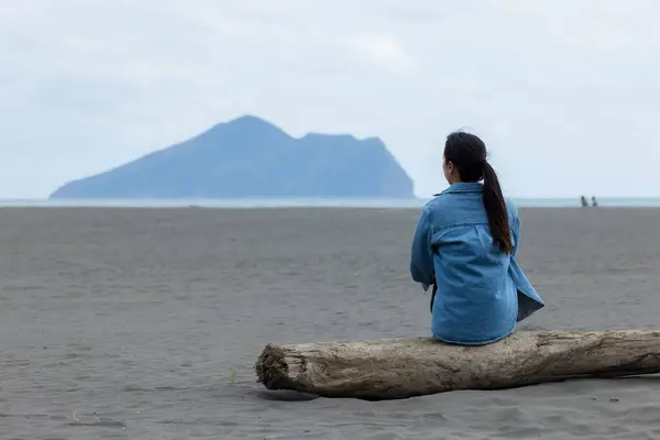 stock image Woman sit on the beach and look at the Guishan at Yilan