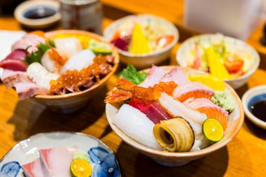 Çeşitli taze sashimi balıklı pilav kasesi.