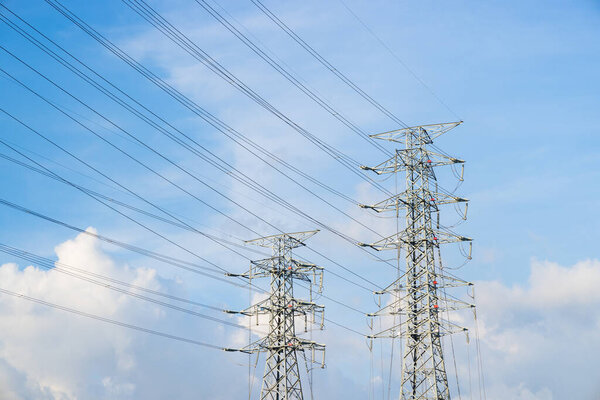 Powerline cables over the blue sky