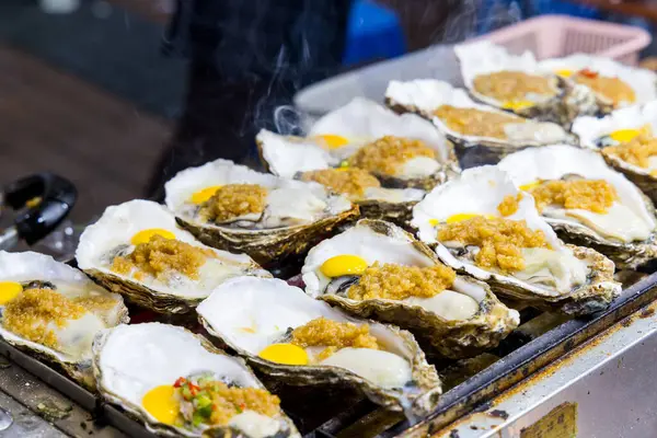 Sokak pazarında sarımsak soslu ızgara istiridye.