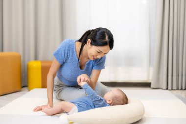 Anne, küçük oğluyla evde oynuyor.