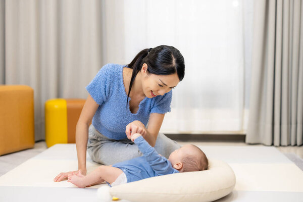 Mom play with her baby son at home