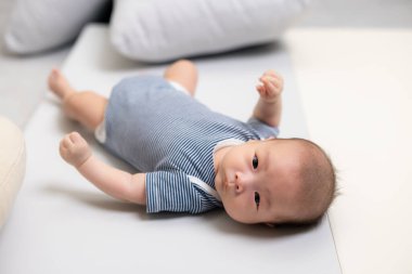 Newborn Baby Lying Comfortably on Mat clipart