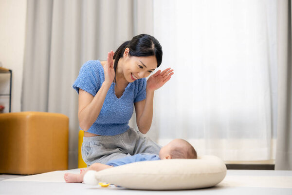 Mom play with her baby son at home