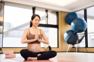 Sakin bir stüdyoda meditasyon yapan bir kadın bekliyordum.