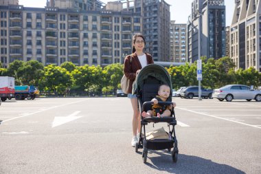 Anne, bebekle bebek arabasında yürü.