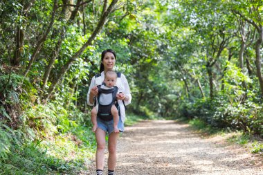 Anne, bebeğini taşıyan oğluyla yürüyüşe çıktı.