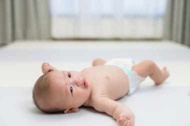 Asyalı Bebek Mat 'in üzerinde huzur içinde yatıyor.