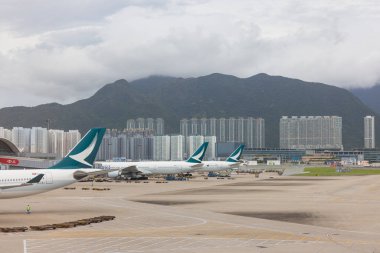 Hong Kong 25 August 2025 : Large Airplane Resting on Hong Kong Airport Tarmac Near Terminal